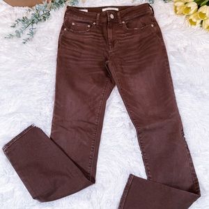 Stacked maroon skinny jeans